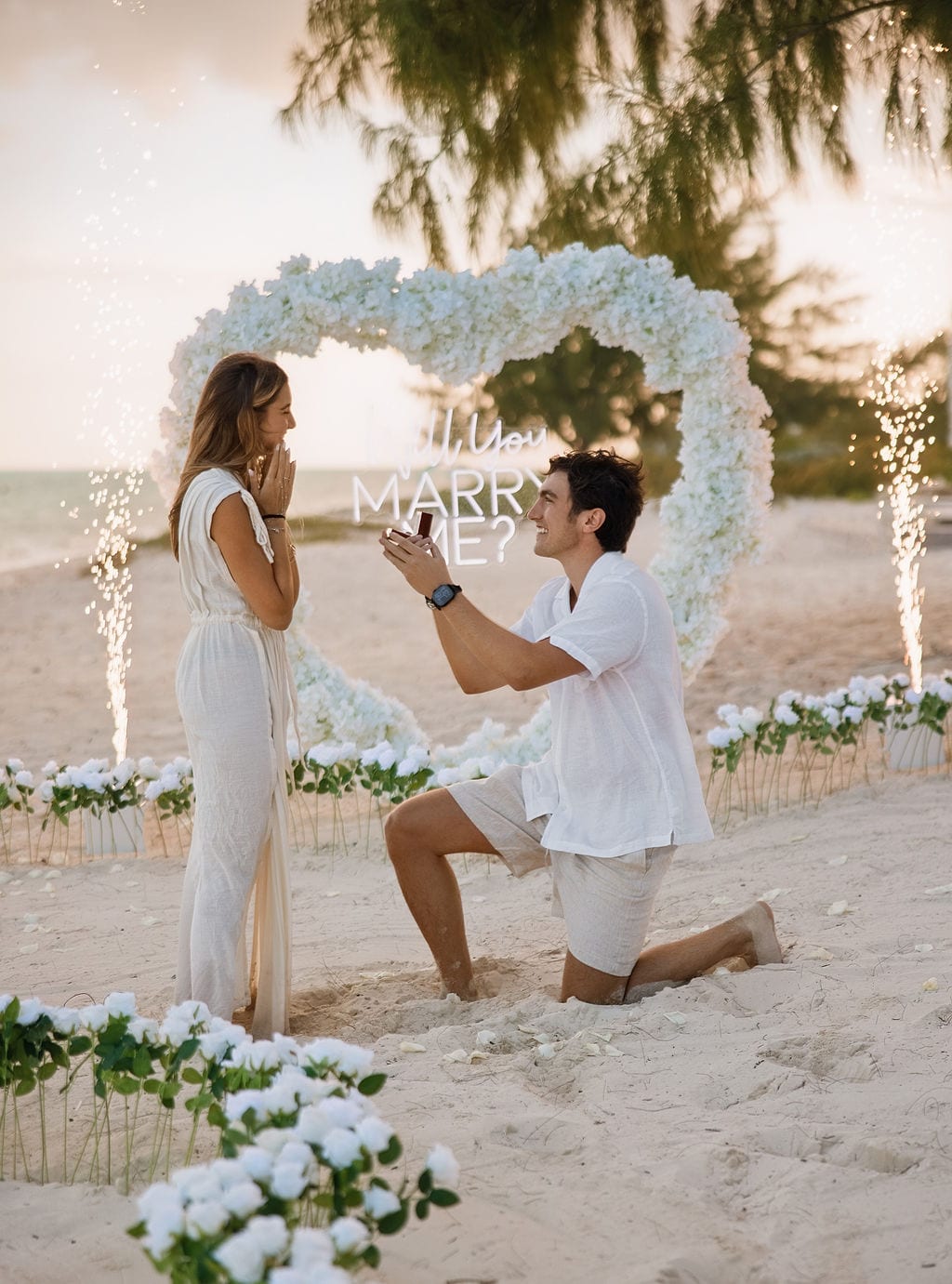 The ring box opens, sparklers either side