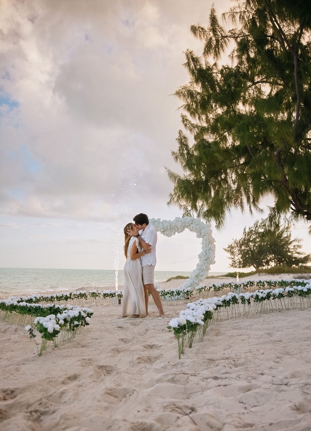 A kiss under the arch as the sparklers burn