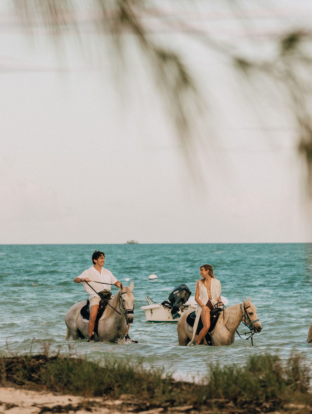 Amit and Alex riding horses through the shallows at sunset, Caesarea